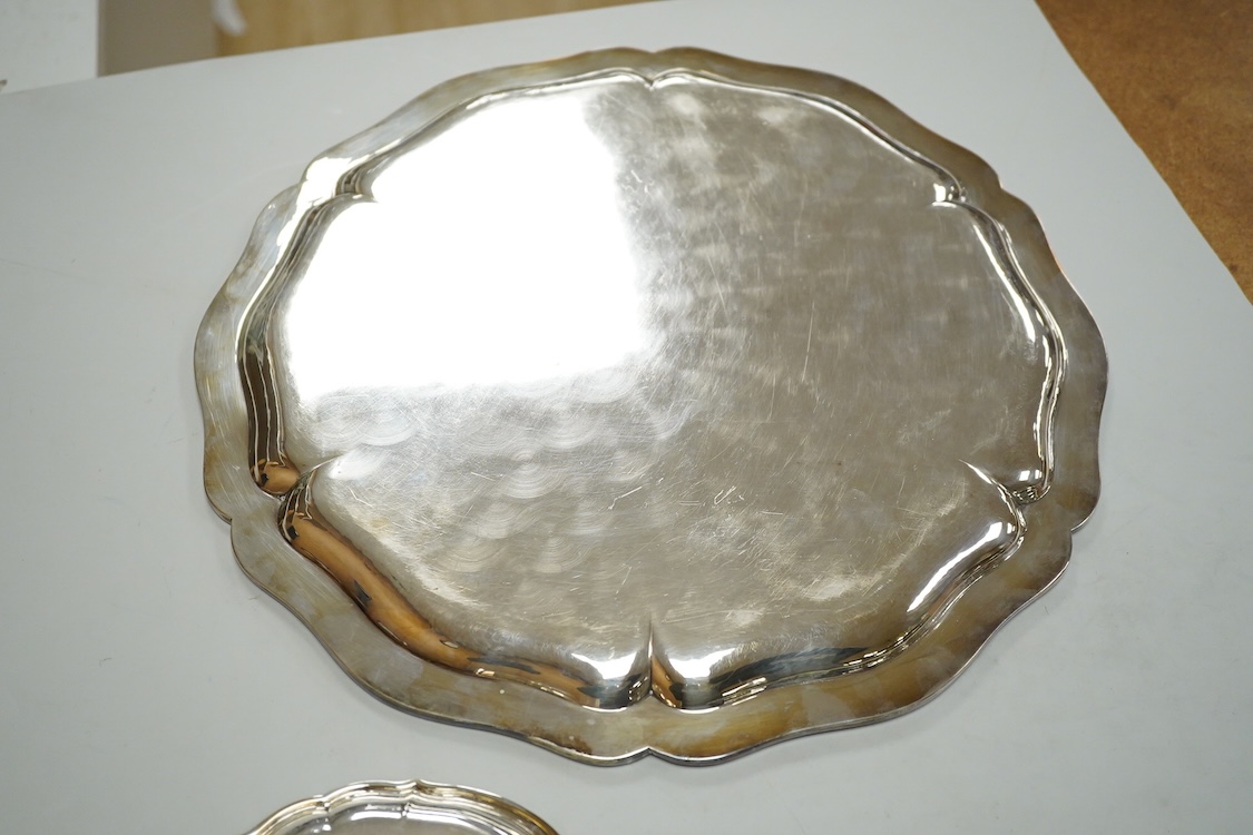 A German 800 standard white metal salver, diameter 35.9cm, together with a similar waiter, diameter 15.6cm, both with engraved armorial, 35oz.